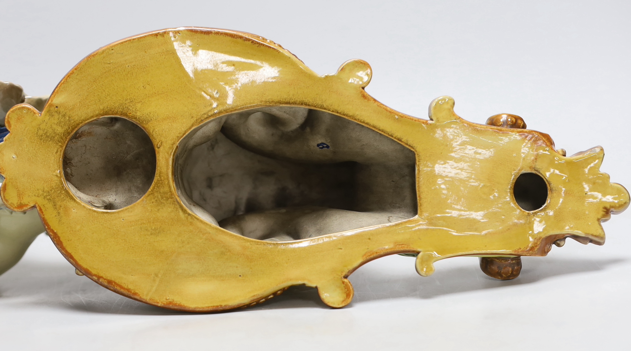 Hughes Protat, a Minton Majolica cherubic wall bracket, incised signature, 42cm high